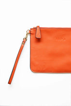 Load image into Gallery viewer, Orange leather clutch with wrist strap and Hoopla brand