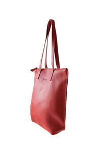 Side view of buttery red soft pebbled leather Hoopla tote bag with a gold coloured zip. 