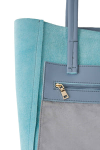 Inside zipped pocket of Hoopla leather blue grey tote. 