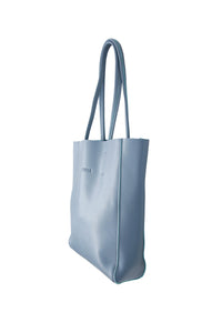 Side view of Hoopla leather blue grey portrait tote with long padded handles.