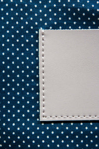 Navy with white polka dot cotton lining on a lavender leather clutch