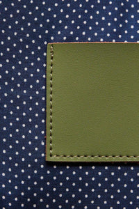 Navy with white polka dot cotton lining on a olive green leather clutch