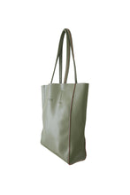 Load image into Gallery viewer, Side view of Hoopla leather olive green portrait tote with long padded handles.