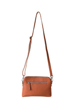 Load image into Gallery viewer, Back view of a ochre leather crossbody bag. With fully adjustable strap and silver zips, Hoopla brand. 