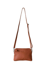 Load image into Gallery viewer, Front view of a ochre leather crossbody bag. With fully adjustable strap and silver zips, Hoopla brand. 