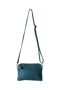 Front view of a teal leather crossbody bag. With fully adjustable strap and silver zips, Hoopla brand. 