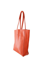 Load image into Gallery viewer, Side view of Hoopla leather orange tote with long padded handles.