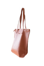 Load image into Gallery viewer, Side view of buttery ochre soft pebbled leather Hoopla tote bag with a gold coloured zip. 